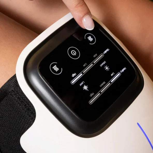 Positioning the Rushify RedLight Massager against the knee